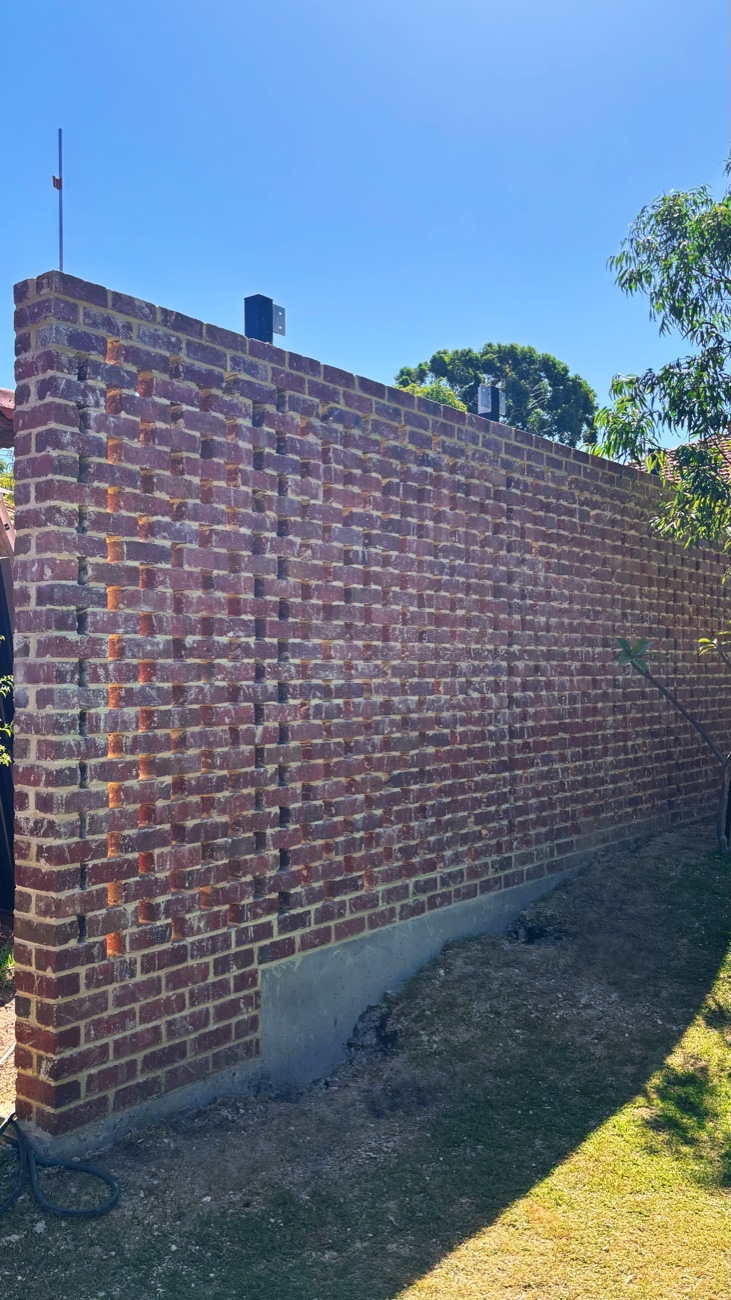 Textured red brick feature wall by Westsite Build Co.
